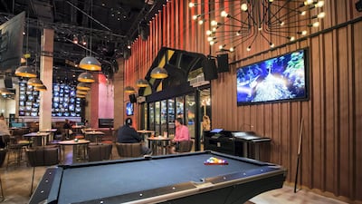 Regular pub games sit alongside the arcade games and VR experiences. Leslie Pableo / The National