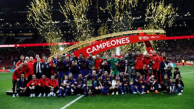 Barcelona players and staff celebrate with the trophy after the match. Juan Medina / Reuters