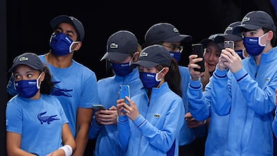 Ball boys and ball girls take pictures on their phones after Spain's Rafael Nadal win his group stage match against Russia's Andrey Rublev. Reuters