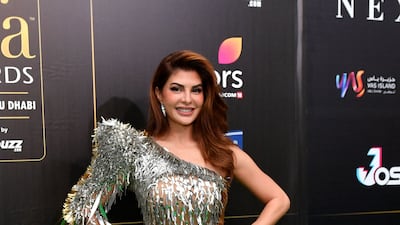 Jacqueline Fernandez, wearing a one-shouldered gold sequinned gown by Jean-Louis Sabaji, walks the IIFA Rocks 2022 green carpet at the Etihad Arena, Abu Dhabi on June 3. AFP