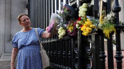Julia Davies from the Cotswolds leaves flowers outside Buckingham Palace in London. Reuters