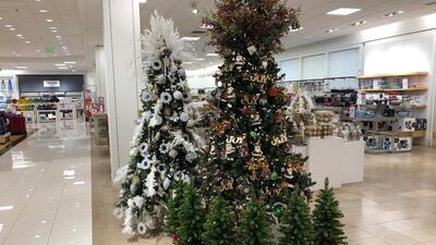 A display of Christmas trees stands next to holiday knick-knacks on display in a Macy's department store. AP Photo