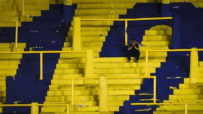A dejected Boca Juniors fans sits in the empty stands after his team lost on aggregate to arch-rivals River Plate in the all-Argentine Copa Libertadores semi-final second leg football match on Tuesday, October 22. Getty