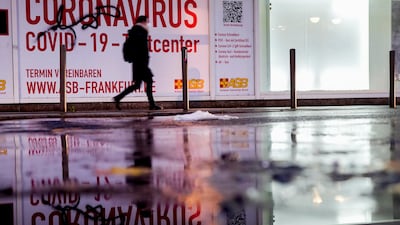 A woman walks past an abandoned coronavirus test centre in Frankfurt. AP Photo