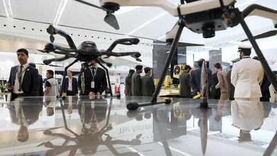 Visitors look at a drone at the MK Unmanned Technologies stand on the first day of the UMEX held at ADNEC in Abu Dhabi. Pawan Singh / The National