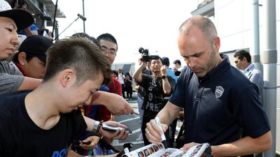 Iniesta signs his autograph for Japanese fans upon his arrival at Kansai International Airport. Jiji Press / EPA