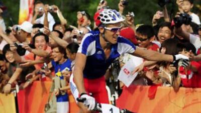 Julien Absalon of France waves to supporters after winning the men's cross-country mountain bike competition.