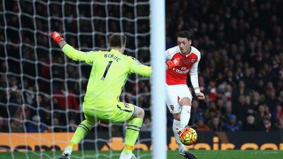 Mesut Ozil of Arsenal scores his team’s second goal against Bournemouth on Monday night. Ian Walton / Getty Images