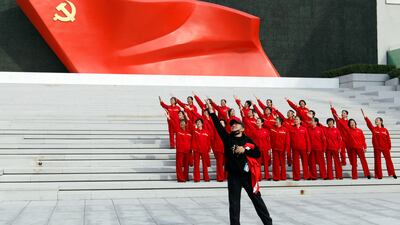 Visitors pose for a video in front of an installation of the Chinese Communist Party flag in Beijing. Reuters