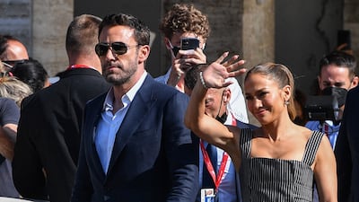 Is Lopez waving or hailing a water taxi for Affleck in Venice? AFP