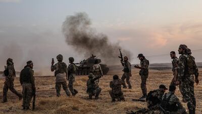 Turkish soldiers and Turkey-backed Syrian fighters gather on the northern outskirts of the Syrian city of Manbij near the Turkish border, as Turkey and its allies continue their assault on Kurdish-held border towns in northeastern Syria. Turkey wants to create a roughly 30-kilometre (20-mile) buffer zone along its border to keep Kurdish forces at bay and also to send back some of the 3.6 million Syrian refugees it hosts. AFP