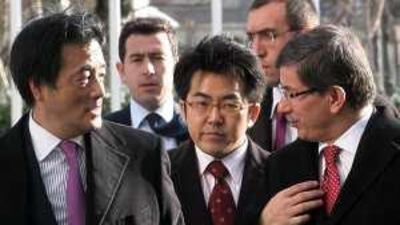 The Turkish foreign minister Ahmet Davutoglu, right, and the Japanese foreign minister Katsuya Okada at the conference in Ankara yesterday.