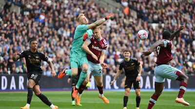 Aaron Ramsdale of Arsenal punches the ball clear under pressure from Jarrod Bowen of West Ham. Getty Images