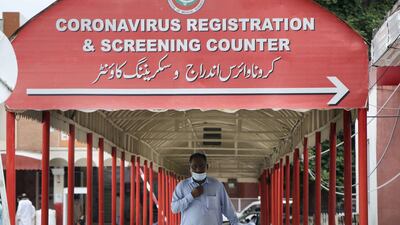 A sign directs visitors to the coronavirus screening counter at the Pakistan Institute of Medical Sciences, the largest public sector health facility in Islamabad. Imran Mukhtar/ The National