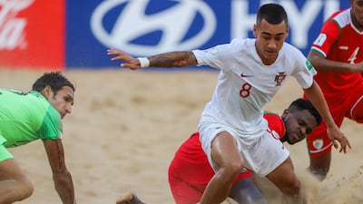 Bernardo Martins of Portugal vies for the ball with Jalal Al Sinani (R) of Oman. EPA