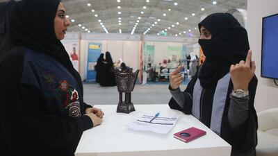A woman is assisted at a job fair in Saudi Arabia. Business activity in the kingdom's non-oil economy hit an eight-year high in February. Getty