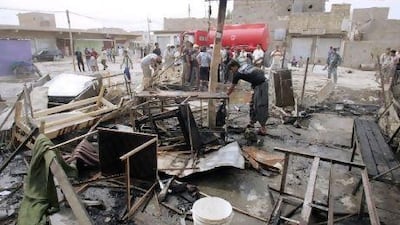 Residents inspect the site of a bomb attack in Balad Ruz in Diyala province, north of Baghdad October 30, 2010. A suicide bomber blew himself up in an Iraqi cafe usually packed with Shi'ite Kurds in a town northeast of Baghdad on Friday, killing at least 22 people and wounding 60, police and officials said. REUTERS/Helmiy al-Azawi
