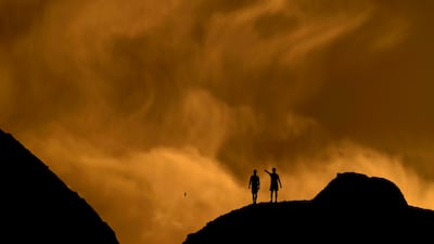 People watch the sunset at a park in Phoenix, Arizona. AP