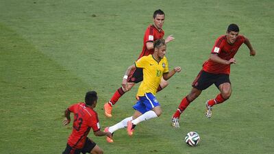 Brazil forward Neymar and Mexico players vie for the ball during their match on Tuesday at the 2014 World Cup. Fabrice Coffrini / AFP