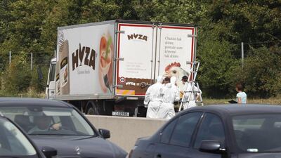 Forensic teams inspect the lorry where the bodies at least 20 migrants were found just off a motorway in Austria. Dieter Nagl / AFP Photo