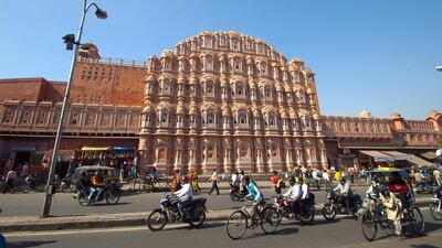 The pink sandstone used to build many of Jaipur’s palaces, including Hawa Mahal, above, gives the city its nickname. Getty Images