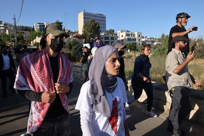 Palestinian activist Muna El Kurd, centre, takes part in a rally to demand the reopening of the Israeli Police checkpoint at the entrance of Sheikh Jarrah, on May 29. AFP