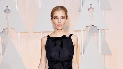 The seriously slimmed-down Sienna Miller wore a black and navy, Oscar de la Renta dress. With a striking apron neckline and a mix of velvet and lace, the ensemble was almost ruined by her excessive contouring and heavy eye make-up. Jason Merritt / Getty Images / AFP