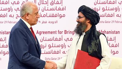 US Special Representative for Afghanistan Reconciliation Zalmay Khalilzad and Taliban co-founder Mullah Abdul Ghani Baradar shake hands during the signing ceremony of the US-Taliban peace agreement in Doha, Qatar. EPA