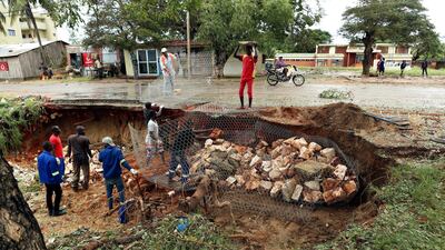 Men repair a road damaged by Cyclone Kenneth in Pemba city on the northeastern coast of Mozambique. Cyclone Kenneth arrived late Thursday, just six weeks after Cyclone Idai ripped into central Mozambique and killed more than 600 people. AP