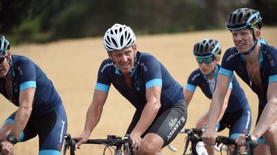 US cyclist Lance Armstrong, centre, rides near Rodez, southwest France, as he cycles a stage of The Tour De France for a leukaemia charity, a day ahead of the competing riders, on July 16, 2015. Armstrong reached a settlement with one of his promer promotion companies over bonuses earned. STEPHANE DE SAKUTIN / AFP