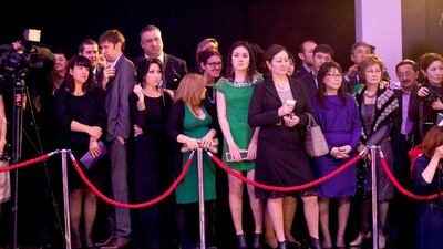 People watch a fashion show at the launch party.
