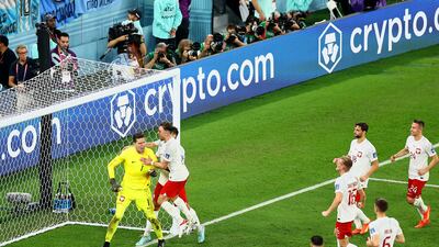 Poland players congratulate Wojciech Szczesny after he saved a Lionel Messi penalty. Getty