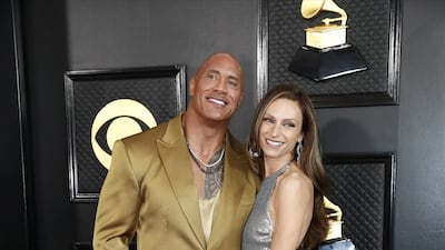 Dwayne Johnson, in a gold suit, arrives with wife Lauren Hashian. EPA