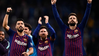 Barcelona's Luis Suarez, left, Lionel Messi, centre, and Gerard Pique celebrate their win at Real Madrid. AFP