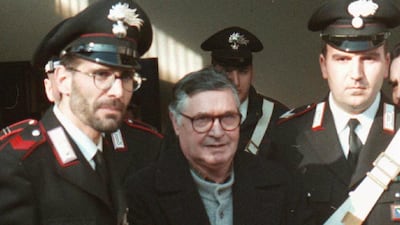 Sicilian mafia boss Salvatore Riina enters a courtroom in Bologna's escorted by Italian paramiliary police on January 16, 1996. Gianni Schicchi / AP Photo