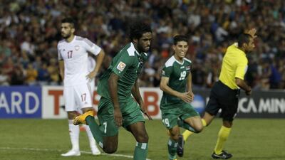 Amjed Kalaf Al-Muntafik wheels away after putting Iraq 2-1 ahead. Jason Reed / Reuters
