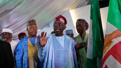 Bola Tinubu of the All Progressives Congress (APC), centre, with his wife Oluremi, right, after winning the presidential elections in Abuja, Nigeria. AP