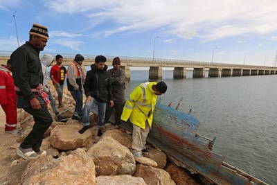 Migrants rescued by Tunisia's national guard during an attempted crossing of the Mediterranean rest on the beach in southern Tunisia. AFP