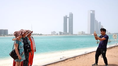 Chinese tourists enjoy the sights at the Heritage Village, Corniche. There has been a drive to improve the experience of tourists with the UAE listed as among the most favoured spots in the world for visitors from China. Victor Besa/The National