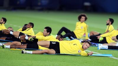 The Al Ain players enjoy a stretch during the training session.