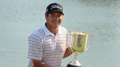 Golfer Daniel Popovic poses with his trophy after winning the Australian PGA Championship.