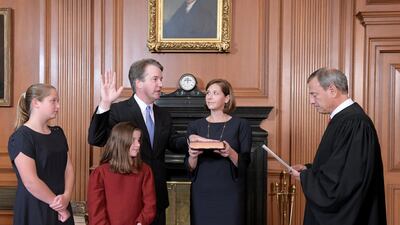 Brett Kavanaugh is sworn in as a Supreme Court justice as his wife Ashley holds the family Bible. via Reuters