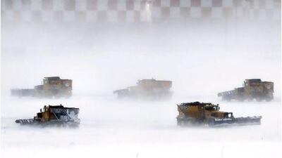 Snow removal crews work to clear runways at Philadelphia International Airport.