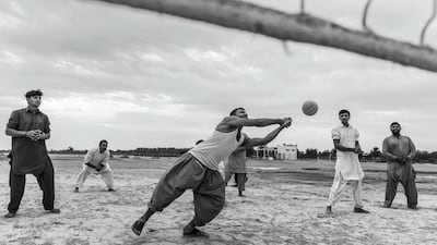 Farm workers and labourers from Pakistan and India play an informal game of volleyball on a desolate patch of sand next to the Sheikh Mohammed Bin Rashid highway halfway between the Dubai and Abu Dhabi highway. All photos Antonie Robertson / The National