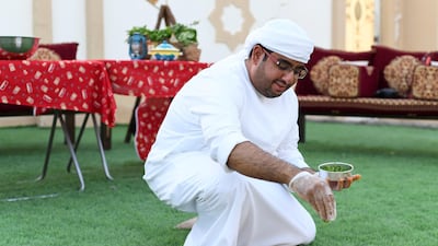 Ali Al Neyadi garnishes the thareed. Khushnum Bhandari for The National
