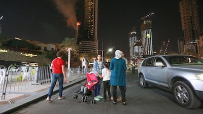 Onlookers viewing the fire at The Address Downtown Dubai on the evening of New's Year Day. Victor Besa for The National.