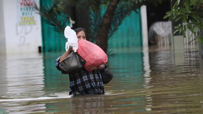 A resident wades through Tanggerang. AP