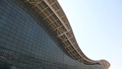 A curved roof sits above a glass wall structure at Abu Dhabi airport's Midfield terminal. Natalie Naccache / Bloomberg