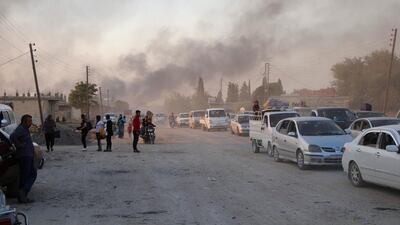 Syrians flee shelling by Turkish forces in Ras Al Ain, northeast Syria. AP Photo