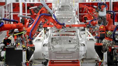 Robotic arms assemble Tesla’s Model S sedans at the company’s factory. Noah Berger / Reuters